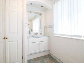 A bathroom with a sink and mirror at 22 Pentire Avenue in Newquay