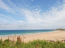 A beach with people and ocean view at 22 Pentire Avenue Newquay