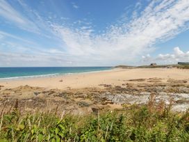 A beach with sand and people at 22 Pentire Avenue Newquay