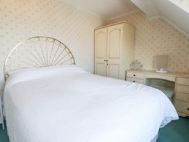 A bedroom with a bed and wardrobe at 22 Pentire Avenue Newquay