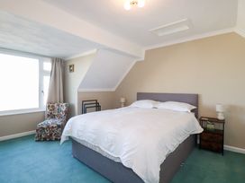 A bedroom with a bed and a chair at Pipers in Newquay