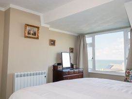 A bedroom with a dresser and mirror at Pipers in Newquay