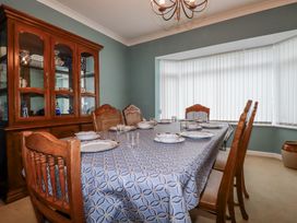 A dining room with a table set for a meal at Pipers Newquay