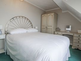 A bedroom with a bed and wardrobe at Pipers in Newquay
