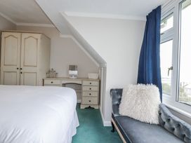A bedroom with a bed and wardrobe at Pipers in Newquay