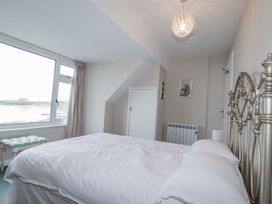 A bedroom with a bed and view at Pipers in Newquay