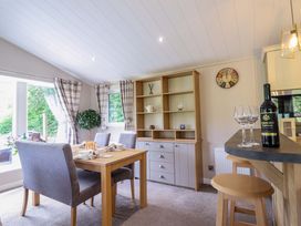 A dining area with a table and chairs at The Owlet in Dolwen near Llanidloes