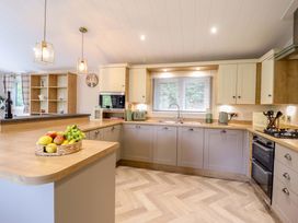 A kitchen with cabinets and a sink at The Owlet in Dolwen near Llanidloes