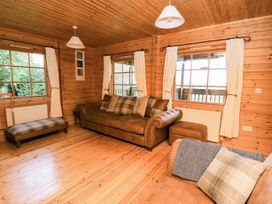 A living room with a sofa and armchair at Dan Y Coed in Beggar's Bush near Presteigne