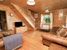 A living room with a sofa and television at Dan Y Coed in Beggar's Bush near Presteigne