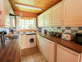 A kitchen with appliances and cabinets at Dan Y Coed near Presteigne