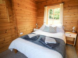 A bedroom with a bed and nightstands at Dan Y Coed Beggar's Bush near Presteigne