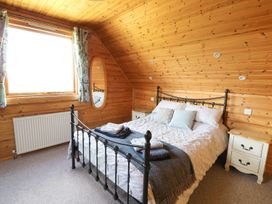 A bedroom with a bed and bedside tables at Dan Y Coed near Presteigne
