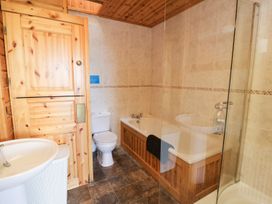 A bathroom with a bathtub and toilet at Dan Y Coed in Beggar's Bush near Presteigne