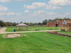 An outdoor area with tables and a shelter at Molly (Cow Shed 6) Woodbridge