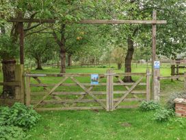 A wooden gate leading to a grassy area at Molly (Cow Shed 6) Woodbridge