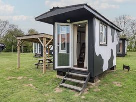 An outdoor area with a cow shed and seating at Molly (Cow Shed 6) Woodbridge