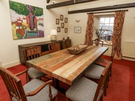 A dining room with a table and chairs at Elford Farmhouse in Seahouses