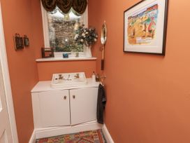A bathroom with sink and cabinet at Elford Farmhouse in Seahouses