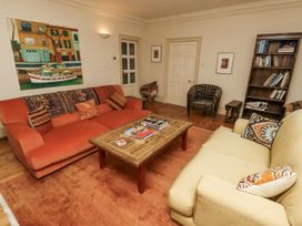 A living room with a sofa and coffee table at Elford Farmhouse in Seahouses