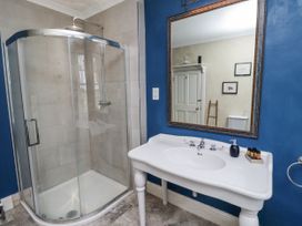 A bathroom with a shower and sink at Elford Farmhouse in Seahouses