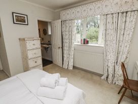 A bedroom with a bed and drawer at Elford Farmhouse in Seahouses