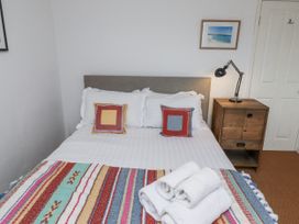 A bedroom with a bed and nightstand at Elford Farmhouse in Seahouses