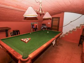 A game room with a pool table and bar stools at Elford Farmhouse in Seahouses
