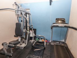 A gym with exercise equipment and a treadmill at Elford Farmhouse Seahouses