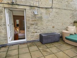 An outdoor patio with a door leading to a bedroom at Elford Farmhouse in Seahouses