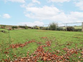 A garden with fallen leaves and a fence at Elford Farmhouse in Seahouses