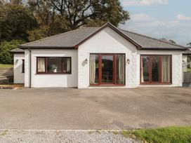 A house with large windows and doors at The Lodge in Bridgend