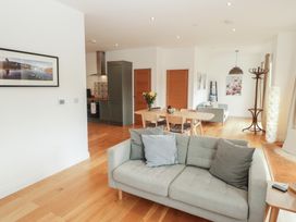 A living room with a sofa and dining table at The Lodge in Bridgend