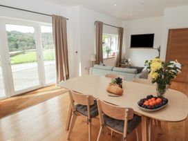 A dining room with a table and chairs at The Lodge in Bridgend