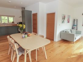 A dining room with a table and chairs at The Lodge in Bridgend