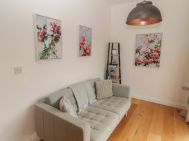 A living room with a sofa and wall art at The Lodge in Bridgend