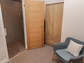 A bathroom with a shower and wardrobe at The Lodge in Bridgend