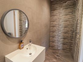 A bathroom with a sink and shower installed at The Lodge in Bridgend