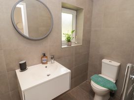 A bathroom with a sink and toilet at The Lodge in Bridgend