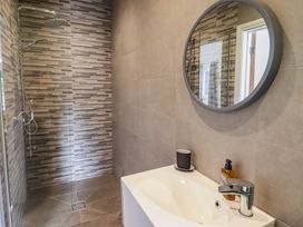 A bathroom featuring a shower and a sink at The Lodge in Bridgend