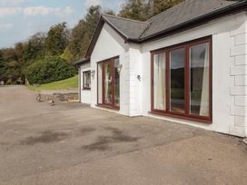 Exterior view of a house with windows and pathway at The Lodge in Bridgend