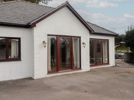 An exterior view of a house with doors and windows at The Lodge in Bridgend