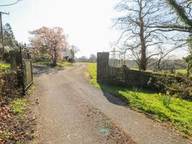 A pathway with a gate and trees at The Lodge in Bridgend