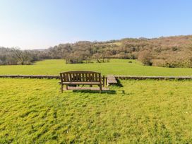 A bench overlooking a grassy field at The Lodge in Bridgend