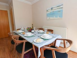 A dining room set up with a table for guests at Farthings in Weymouth