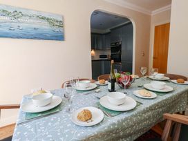 A dining room with a table set for a meal at Farthings in Weymouth