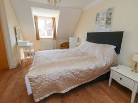 A bedroom with a bed and furniture at Farthings in Weymouth