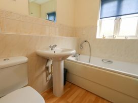 A bathroom with a toilet sink and bathtub at Farthings in Weymouth