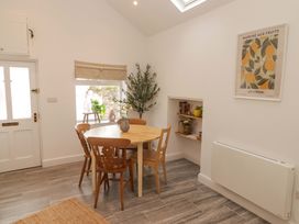 A dining room with a table and chairs at Penwyn in Solva