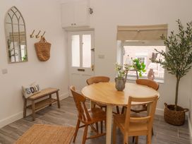 A dining room with a table and chairs at Penwyn in Solva